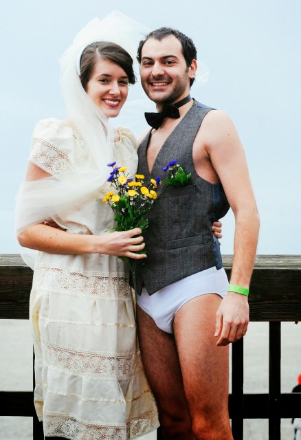 Bride and groom taking the polar plunge on Tybee Island.